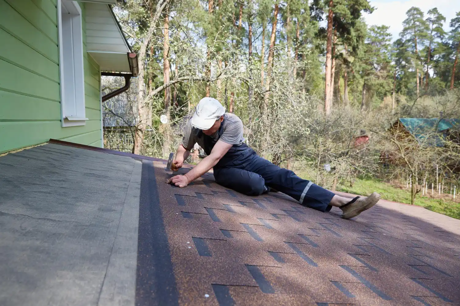Contractor replacing damaged and missing roof shingles