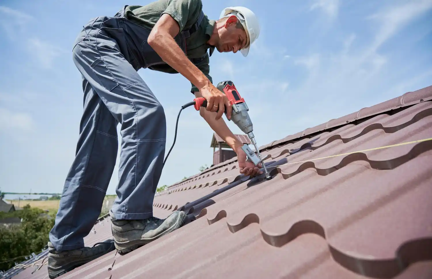 Roofer inspecting roof surface for damage, leaks, and missing shingles