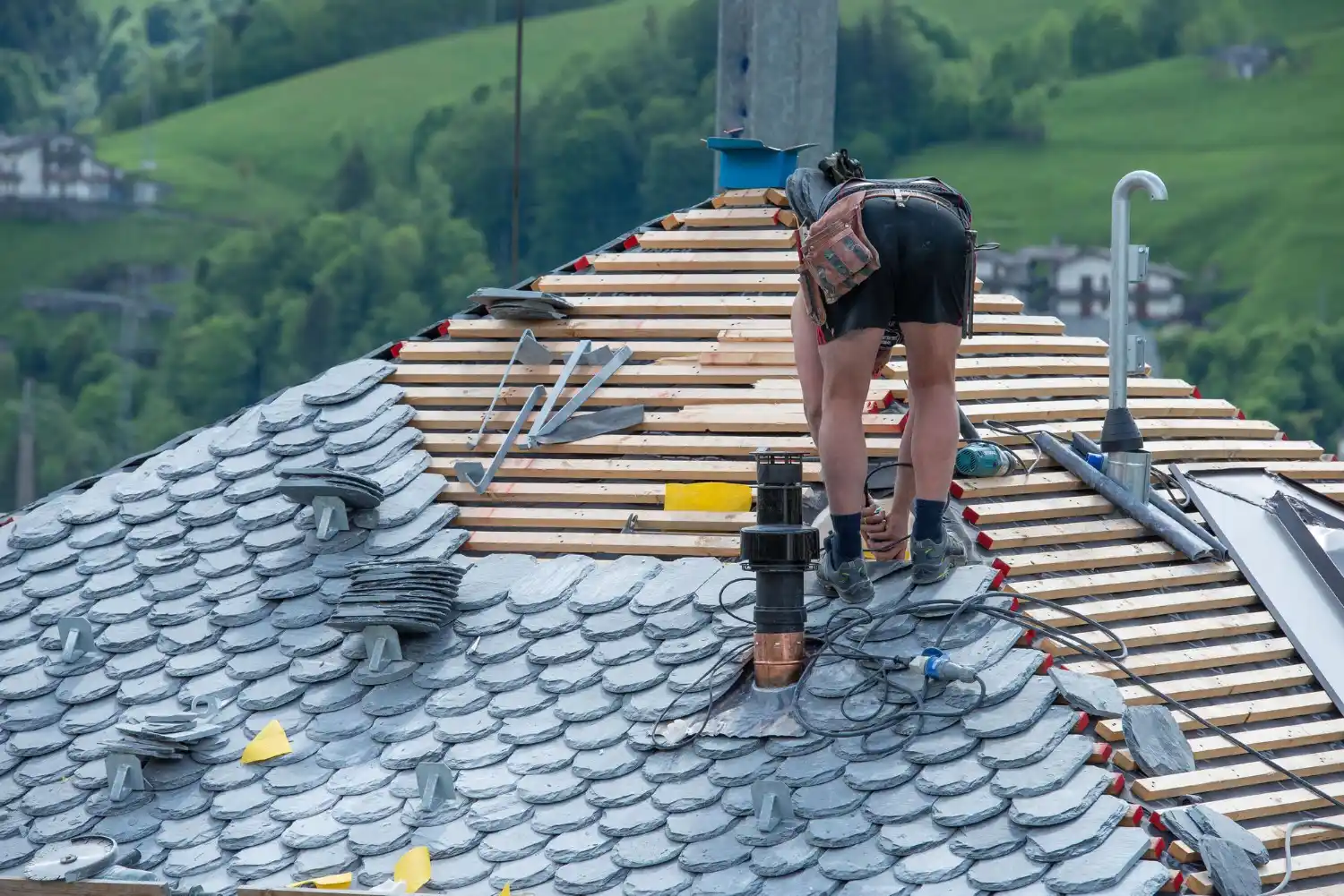 Technician repairing leaking roof to prevent interior water damage