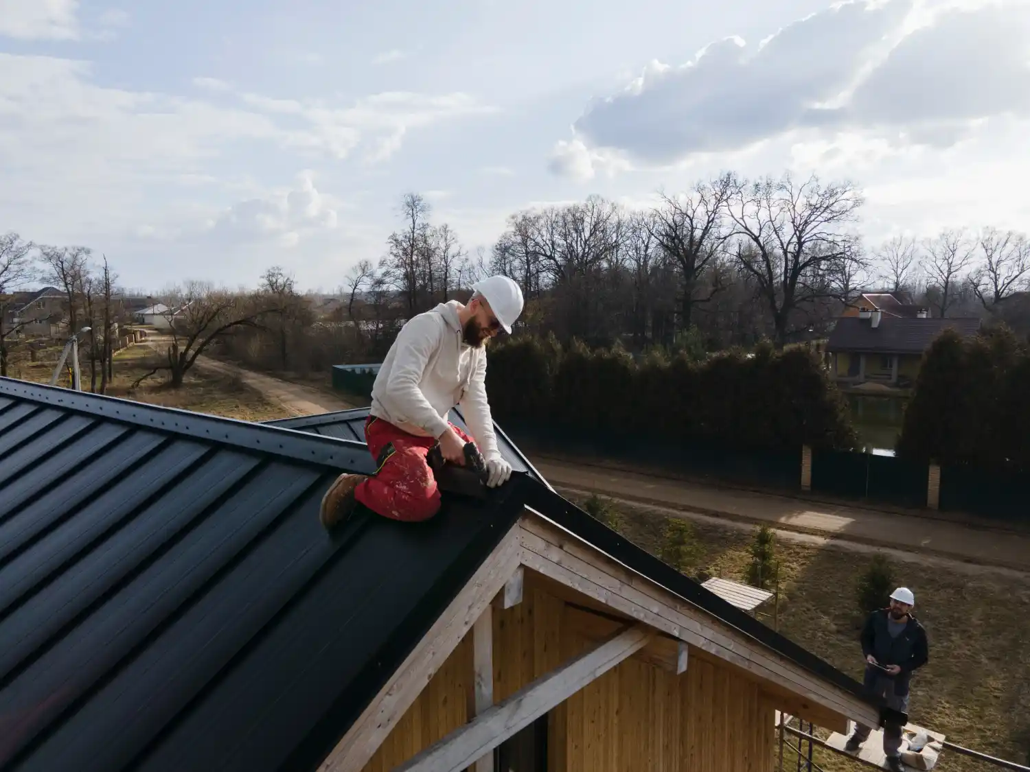 Emergency roof repair team fixing storm-damaged roof in Bowling Green KY to prevent leaks and structural damage.