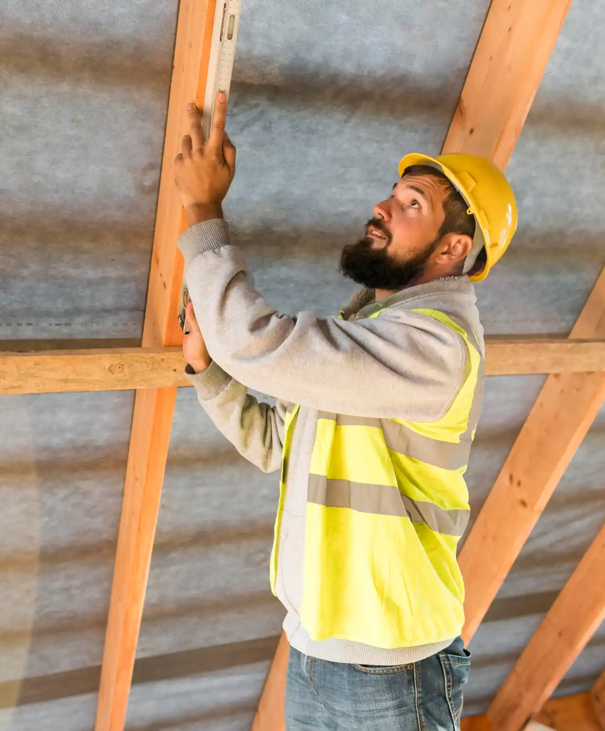 Inspector checking ceiling and interior walls for roof water damage and leaks