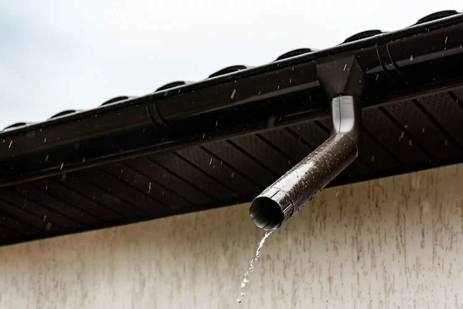 Contractor repairing sagging gutter system attached to roofline