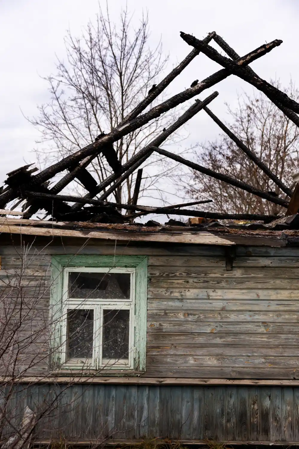 Residential roof damaged by storm requiring urgent repair service